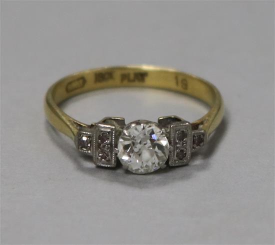 An 18ct gold single stone diamond ring with diamond set shoulders,